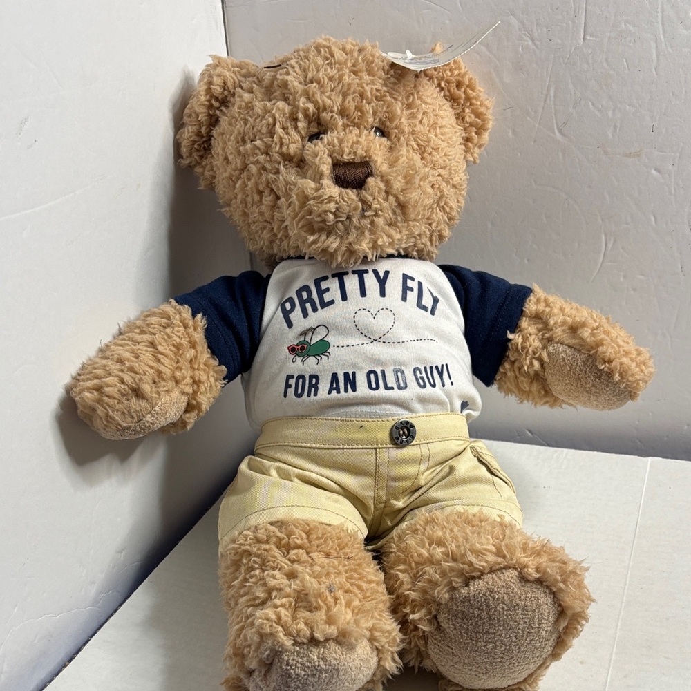 Build-A-Bear Tan Teddy The T-shirt features text: "PRETTY FLY FOR AN OLD GUY!"